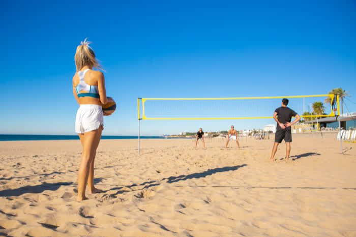 A beach volleyball game in the afternoon