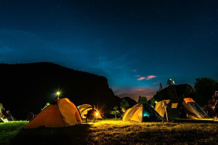 Tents lit from inside at dusk