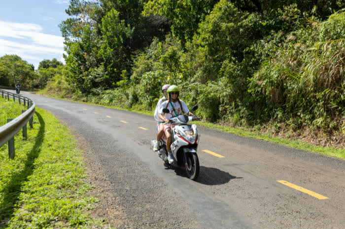 A scooter on a coastal road